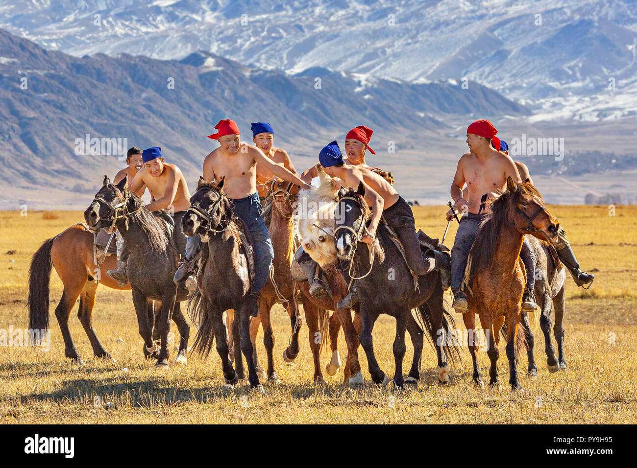 Local people play the nomadic horse game known as Buzkashi or Kokpar, in Issyk Kul, Kyrgyzstan Stock Photo