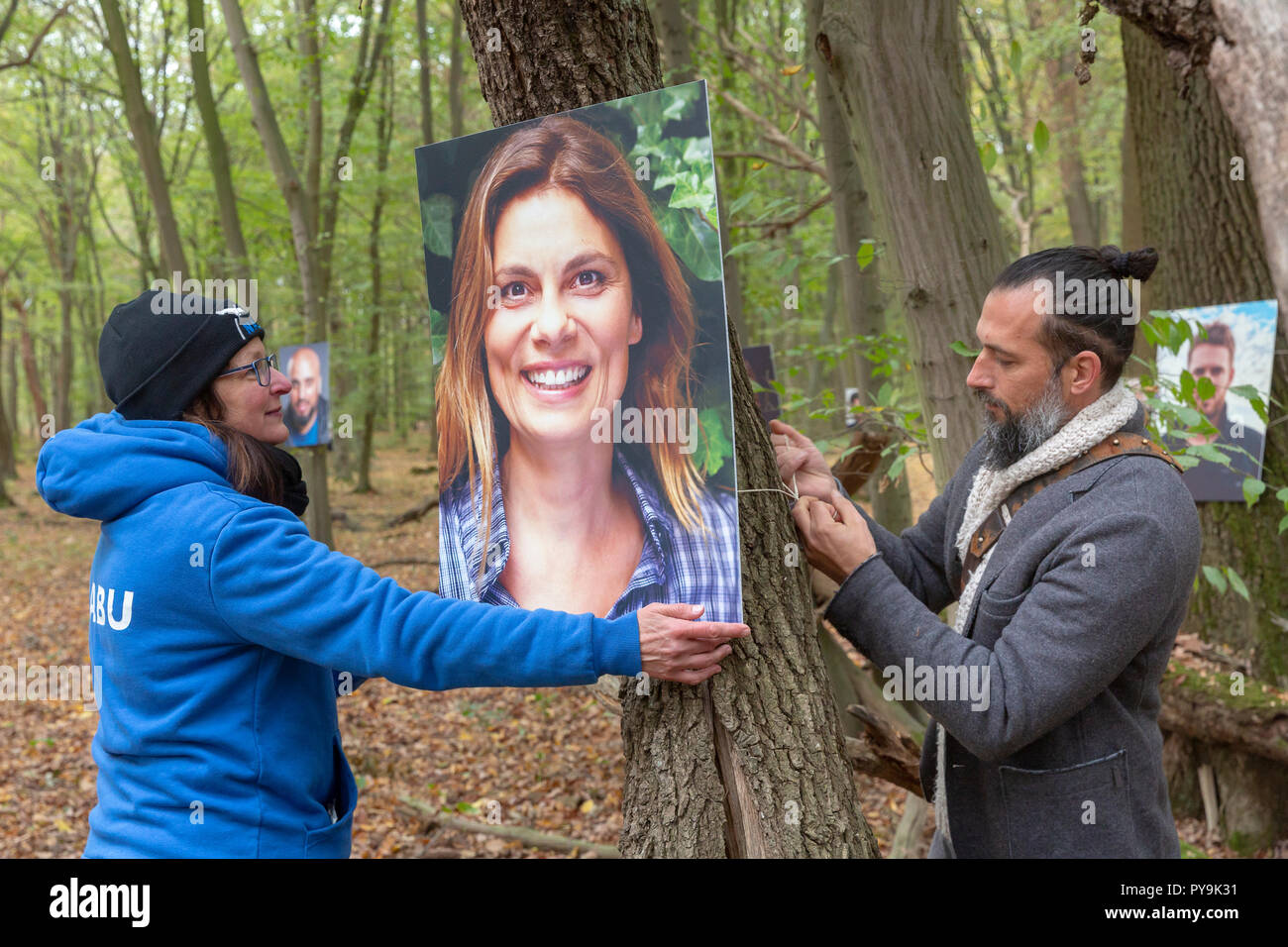 Roy Schroeter and Anette Wolff (Nabu) hang up a photo of Sarah Wiener (TV chef) Stock Photo