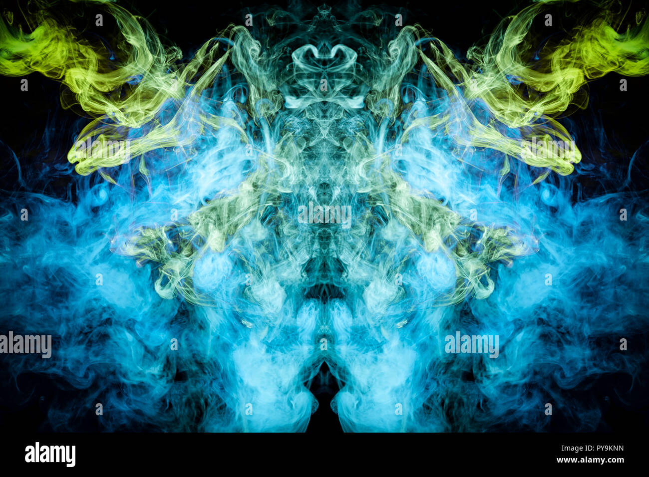 Cloud of blue, green smoke  in the form of a skull, monster, dragon  on a black isolated background. Background from the smoke of vape. Mocap for cool Stock Photo