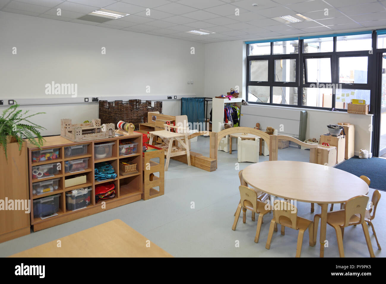 Interior of a nursery classroom in a new London primary school. Shows natural timber furniture.Empty, no pupils. Stock Photo