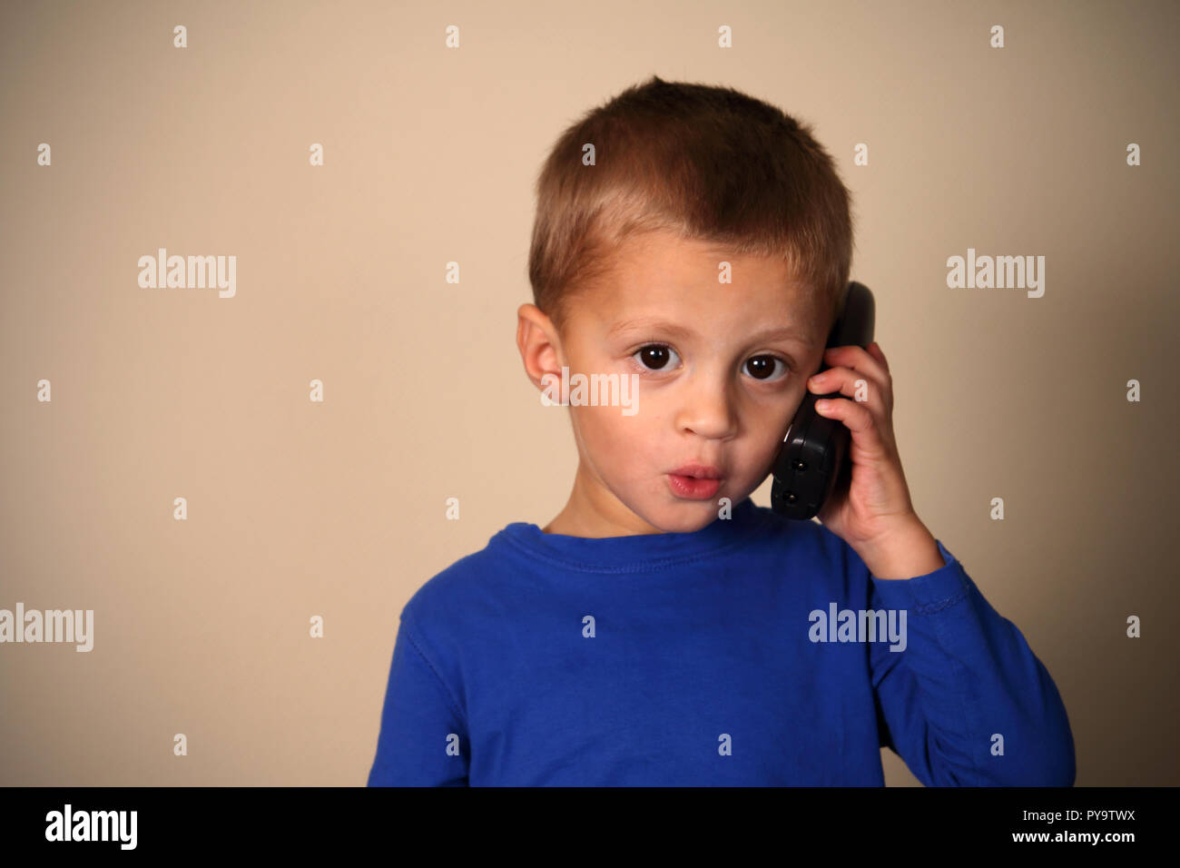 Cute boy talking on the telephone Stock Photo