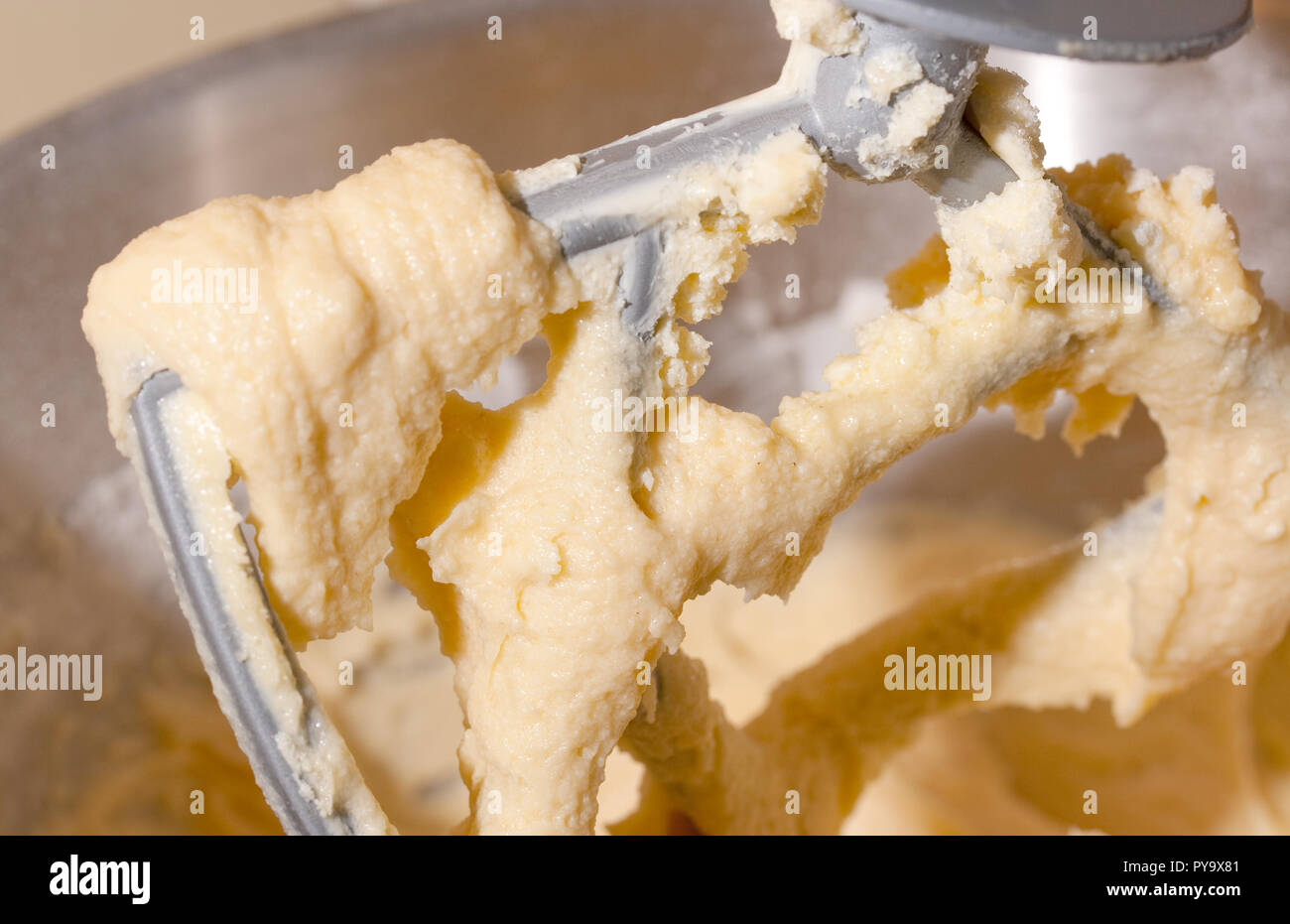 Mixing flour, butter and sugar into a batter for cakes Stock Photo