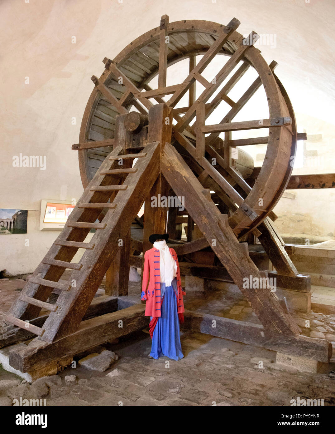 The tread mill used as punishment to draw water up from a deep well and also used to discipline misbehaving army recruits, Fort Mount Louis, France Stock Photo