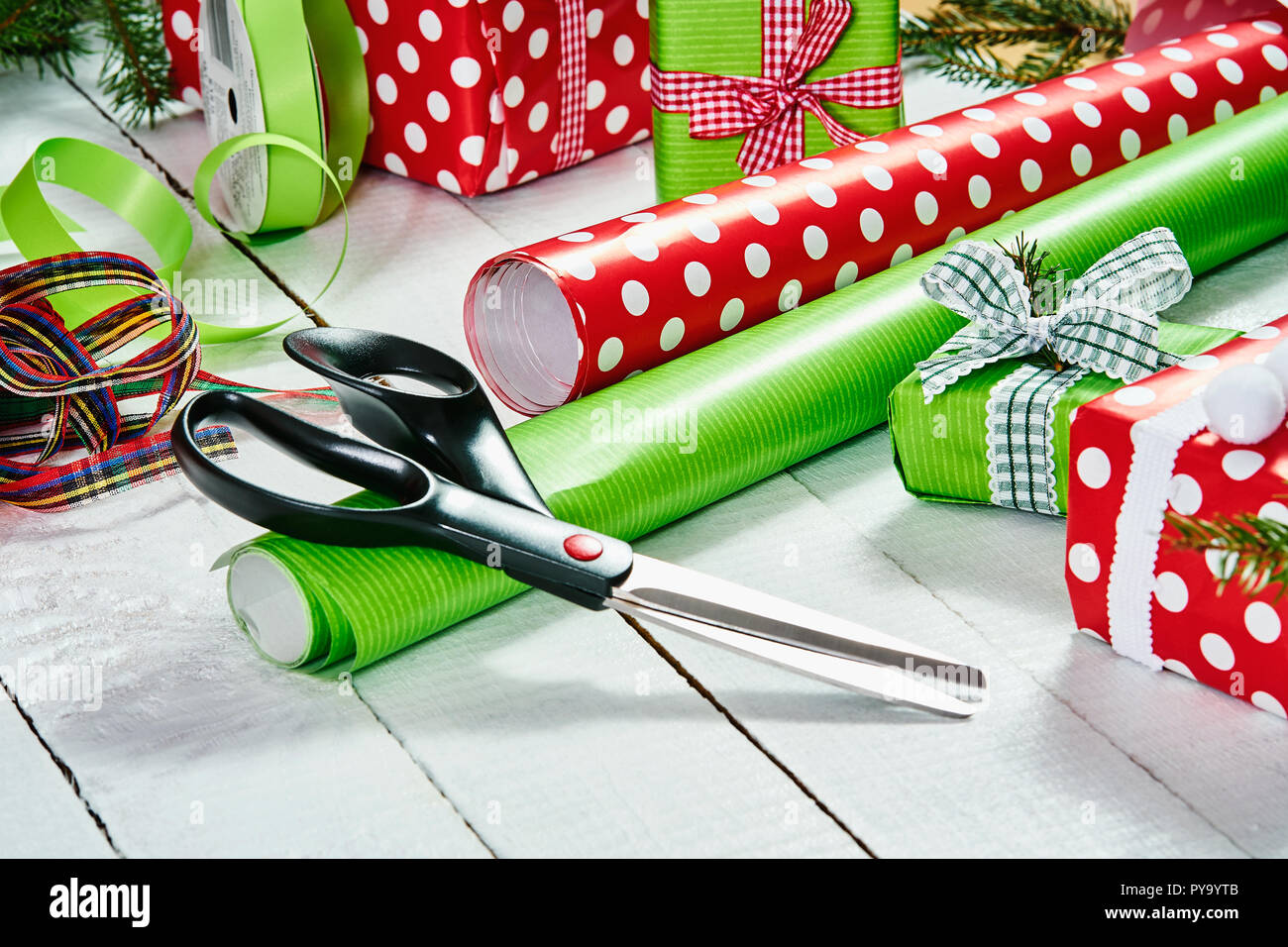 Rolls of colorful wrapping paper, scissors and ribbons on white background,  top view Stock Photo - Alamy