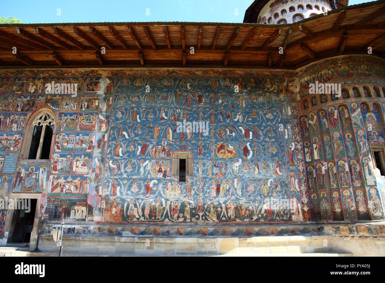 Frescoes on exterior of Voronet Monastery Church, painted using Voronet Blue paint, part of the Bucovina Monastery group in Romania Stock Photo