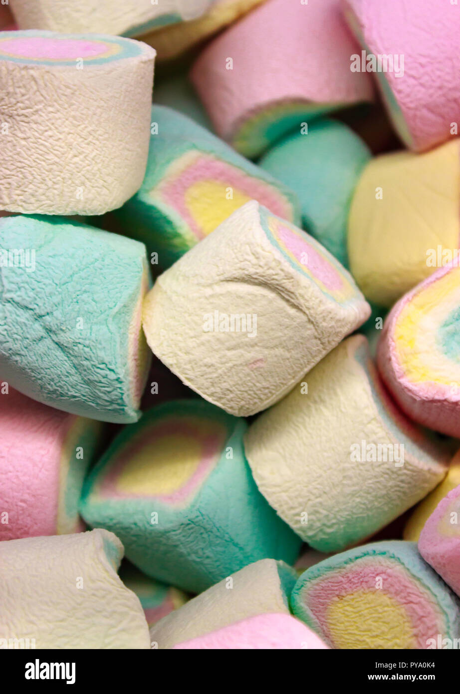 A close up image of pastel colored yellow, pink, blue and green marshmallows. Stock Photo