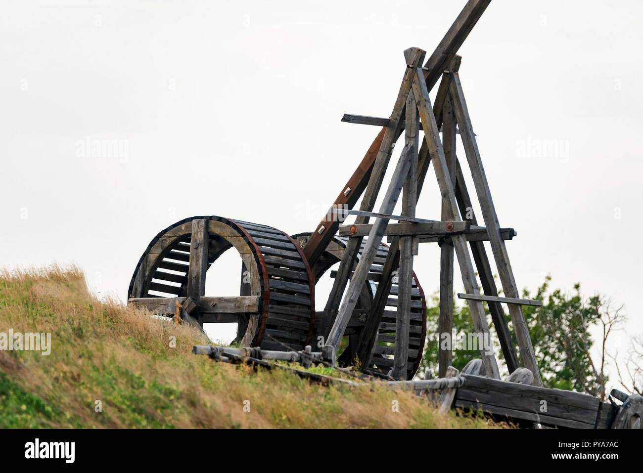 Old wooden catapult against grey sky background Stock Photo