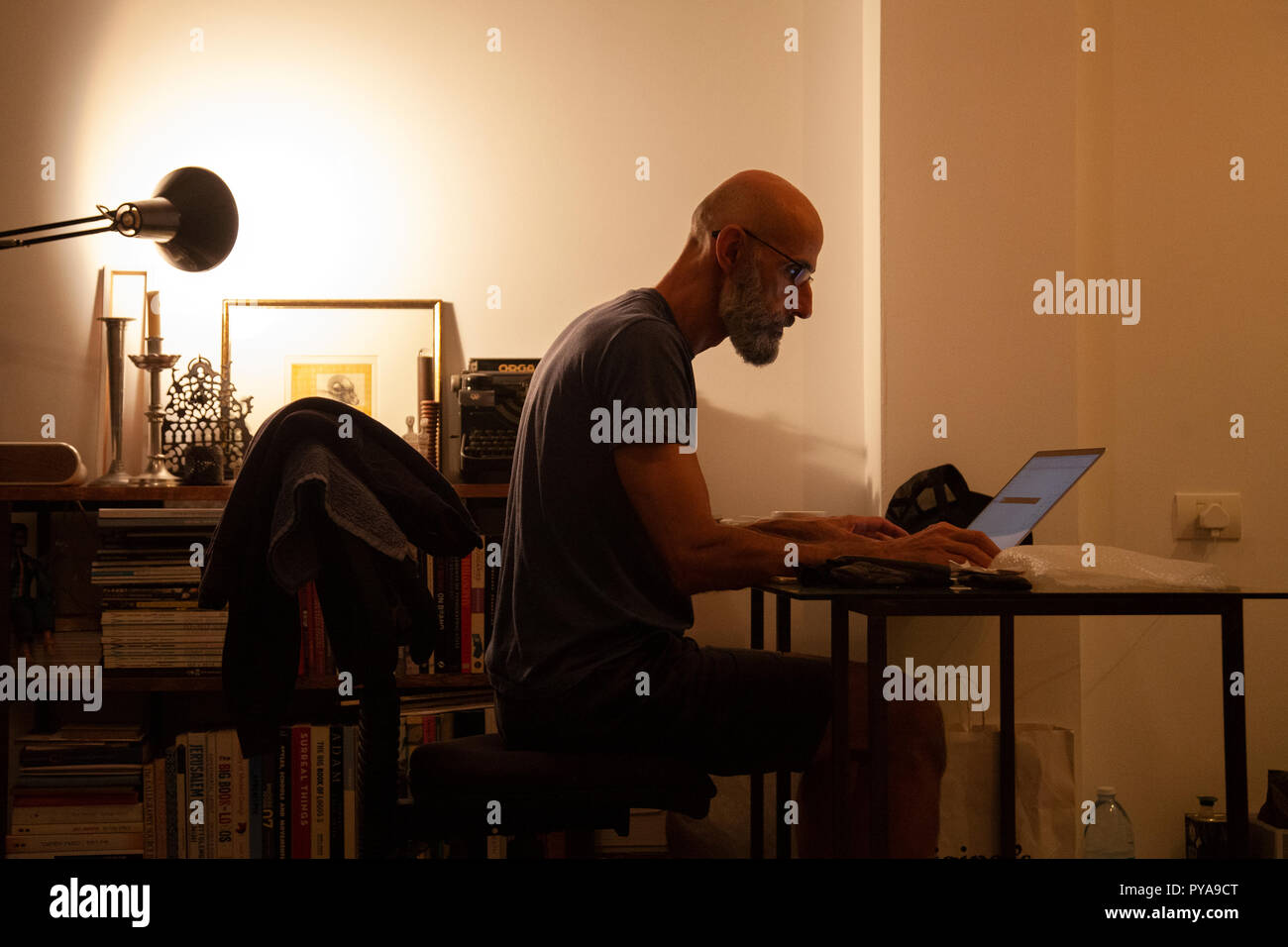 Man Working at Desk at Home Stock Photo