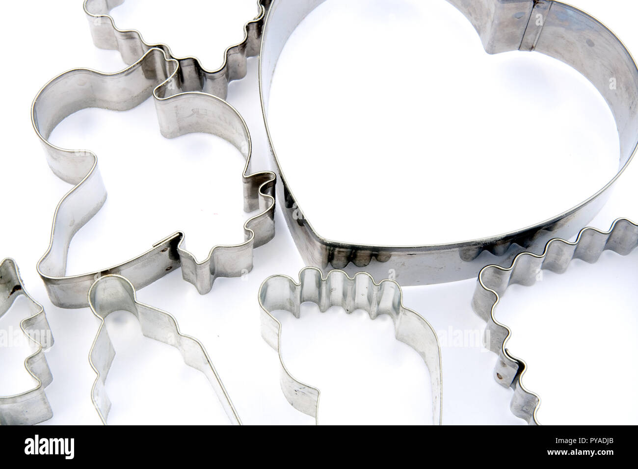 Stainless steel cookie cutters on white Stock Photo - Alamy