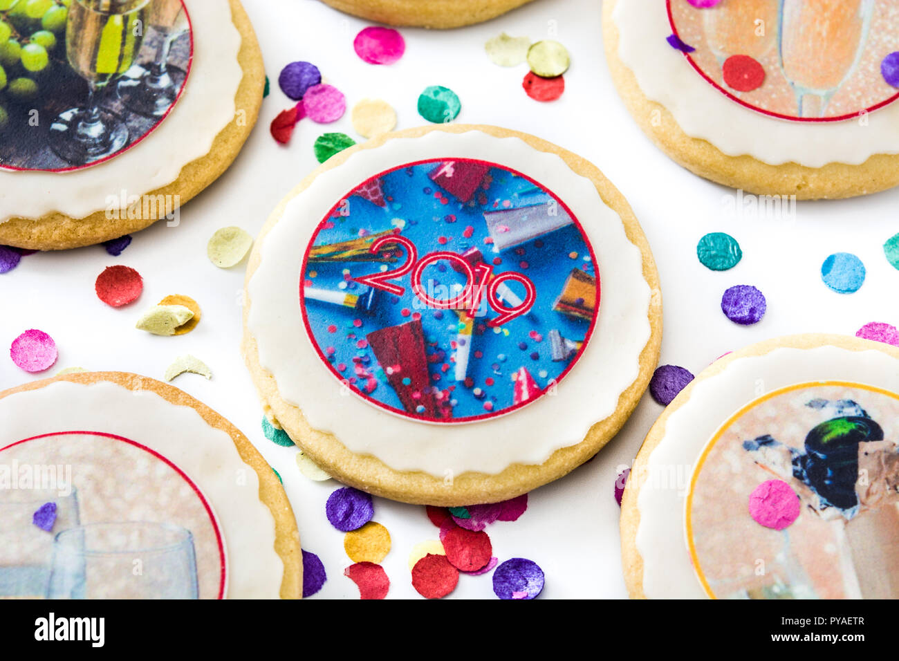New Year cookies and confetti on white background Stock Photo