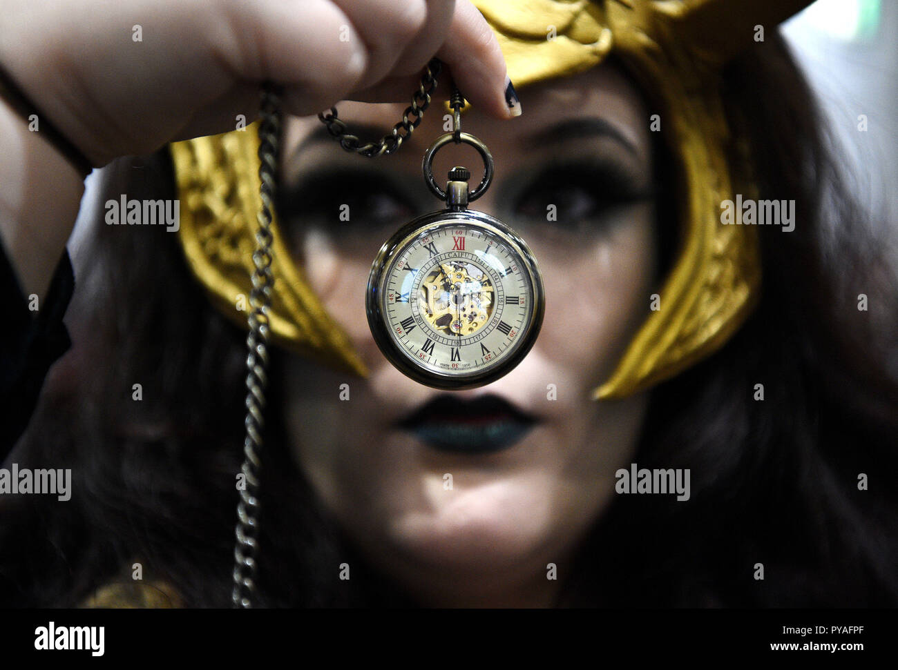 A cosplayer at the London Comic Con at the ExCel London, holds up a