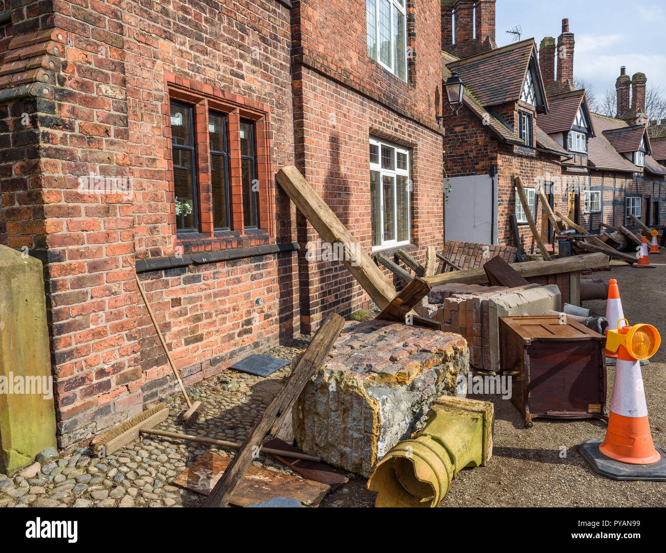 Props and debris litter alongside cottages for  the new BBC drama 'War Of The Worlds' by HG Wells,filmed at Great Budworth village, Cheshire, April 20 Stock Photo