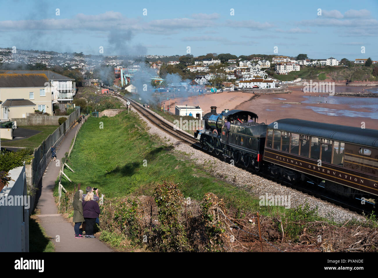 Locomotive Lydham Manor hauls train past Goodrington Sands on the  Dartmouth Steam Railway, Paignton, Devon, UK Stock Photo