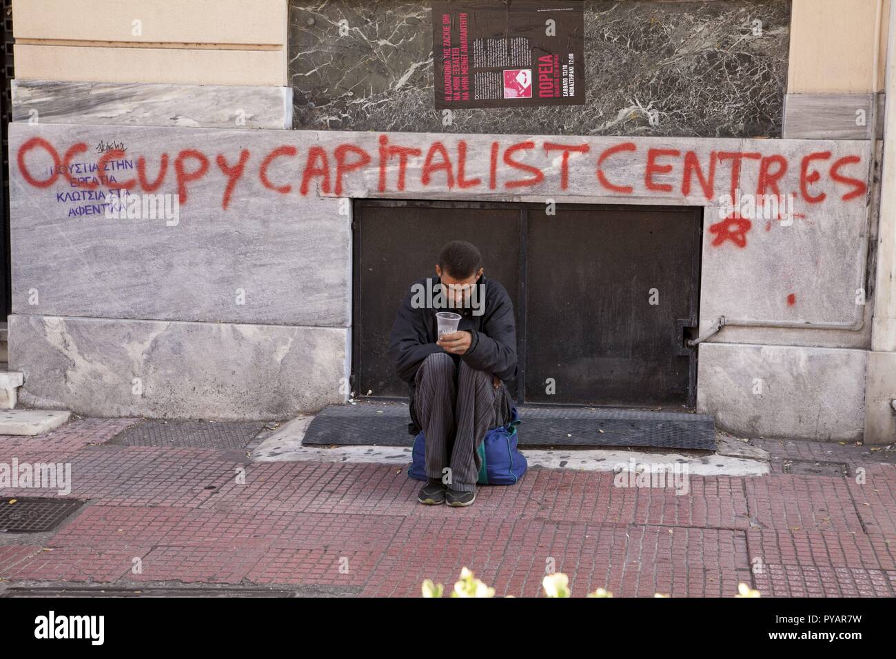 Homeless person in Athens, Writing on the wall 