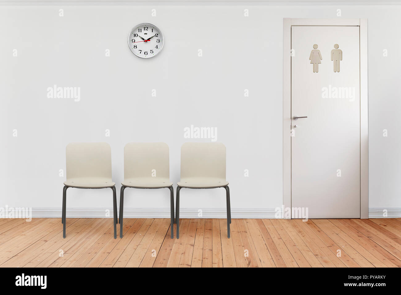 empty waiting room with chairs, clock on wall and bathroom door. Stock Photo