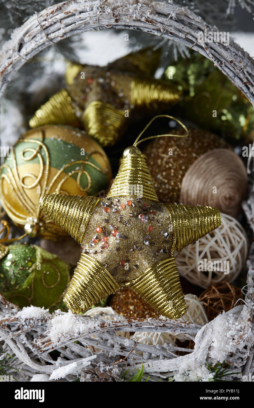 Wicker basket with Christmas gifts, toys and holiday decorations under