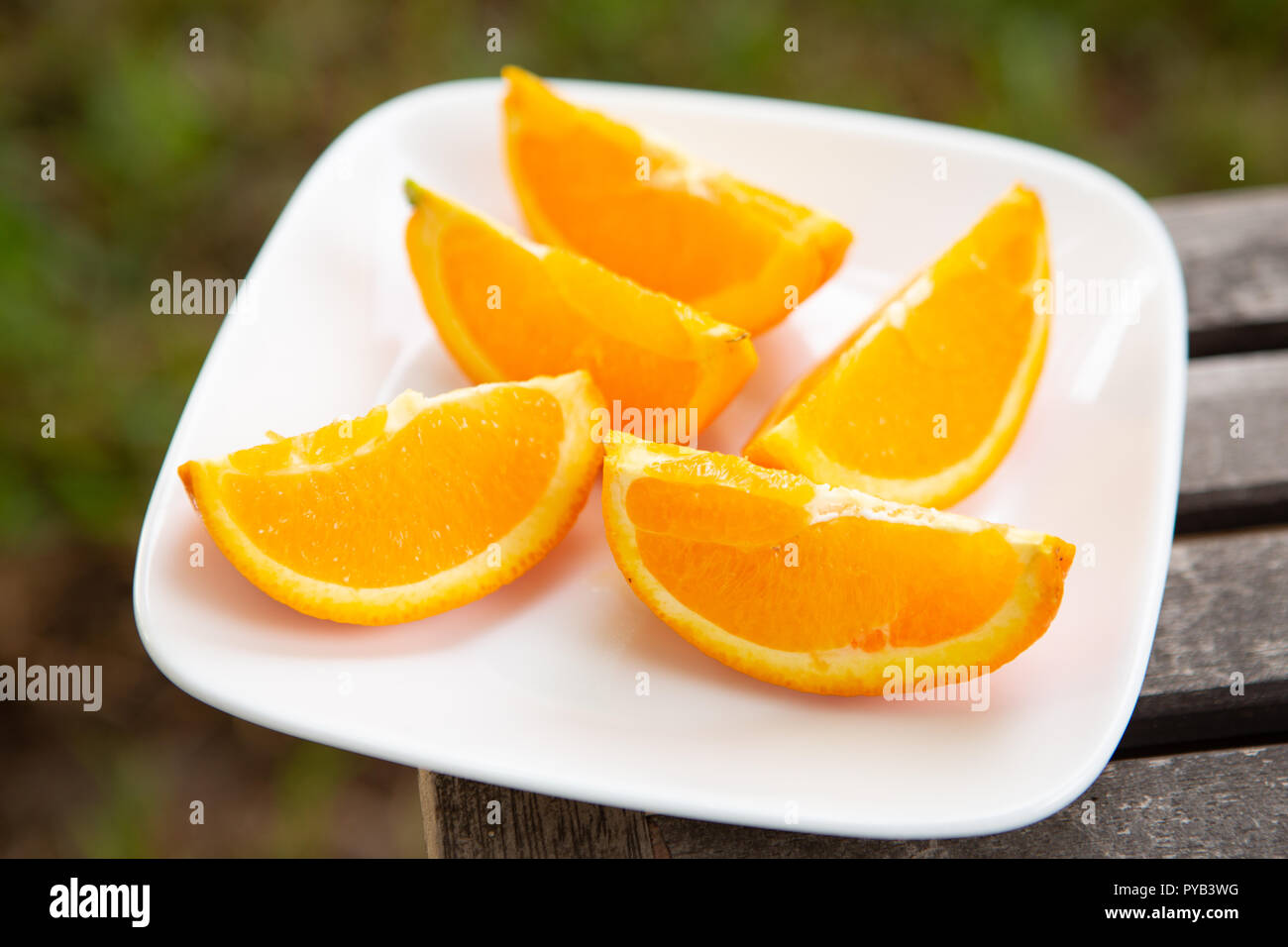 orange wedges on white plate set on 