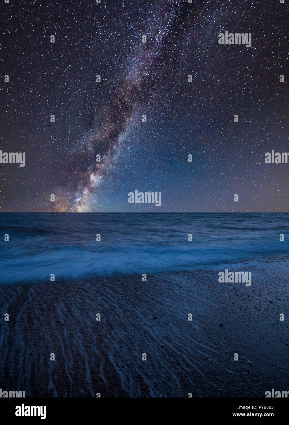 Stunning vibrant Milky Way composite image over landscape of beach long ...