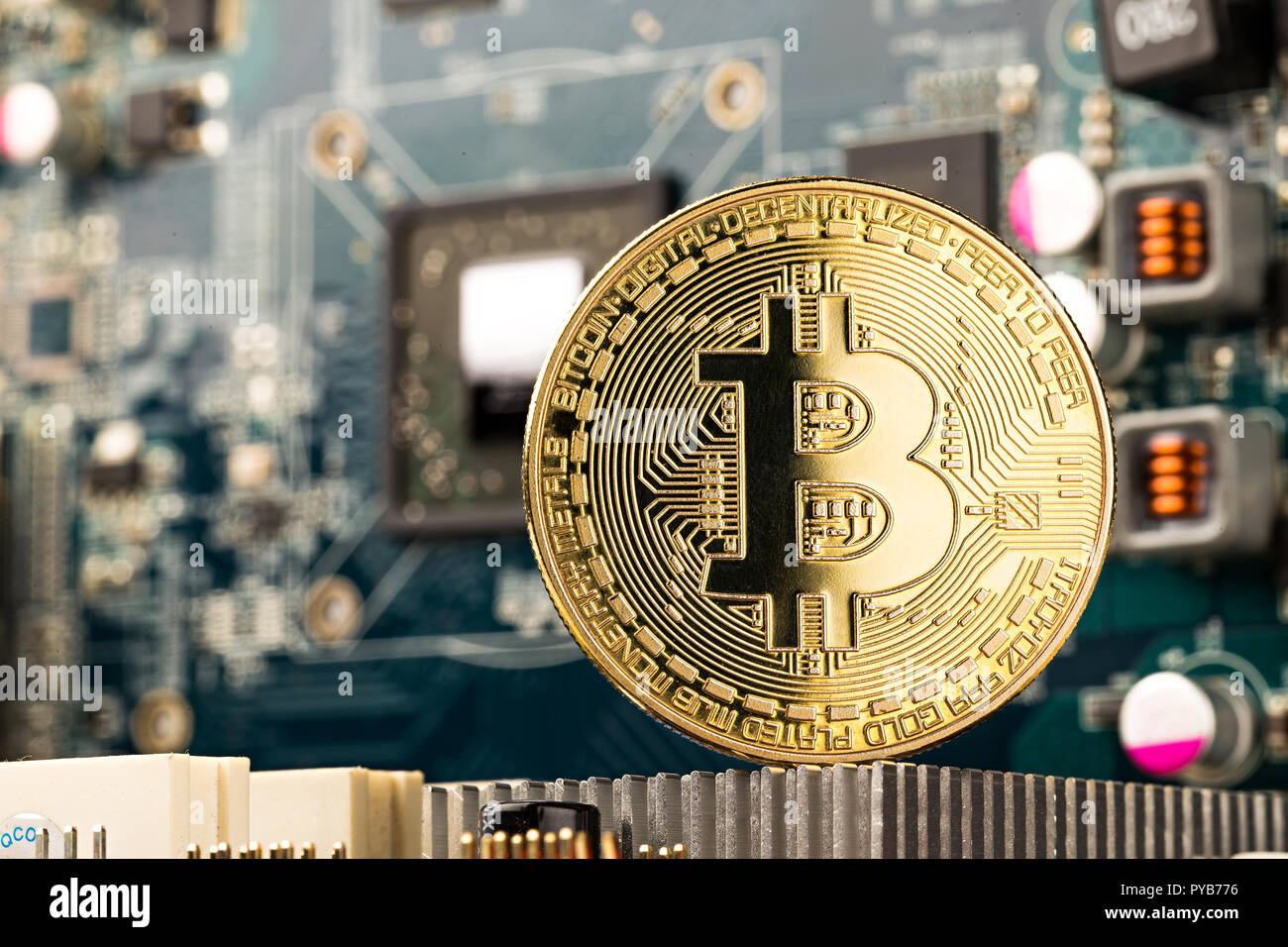 bitcoin golden coin on graphic card motherboard chip digital mining computer hardware crypto