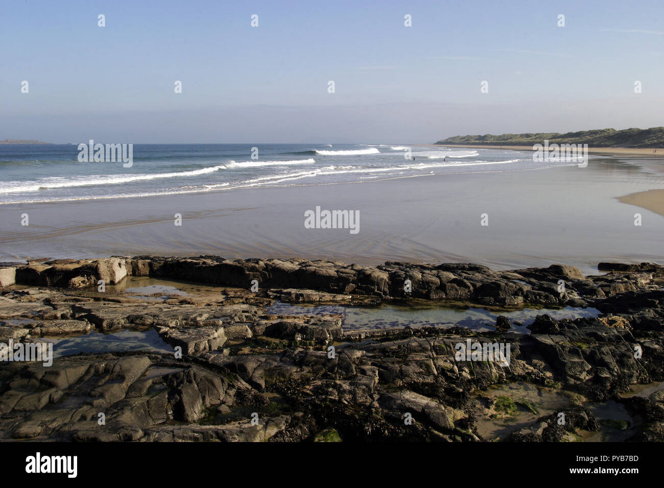 The sea and the beach at the town of Portrush looks tempting enough to go for a dip. I'll bet is freezing though. It is much more pleasurable looking at the beauty of it. Stock Photo