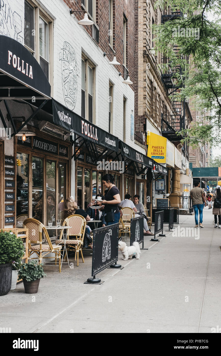 NEW YORK, USA - MAY 29, 2018: Waitress brings food to the people