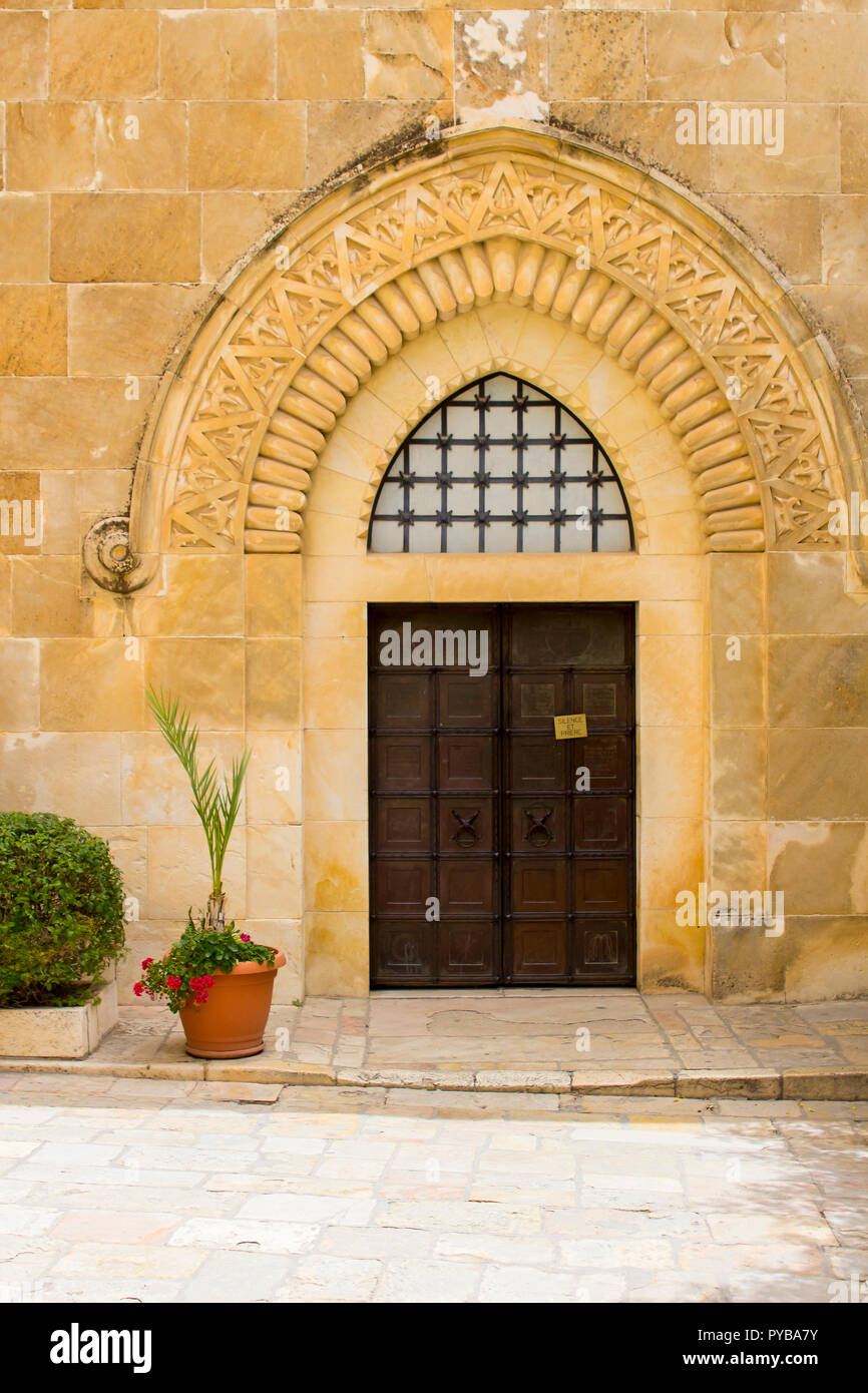 The door of the Church of St Ann at the ancient site of the Pool of Bethesda in Jerusalem Israel. The ornate stonework is a distictive achitectural fe Stock Photo