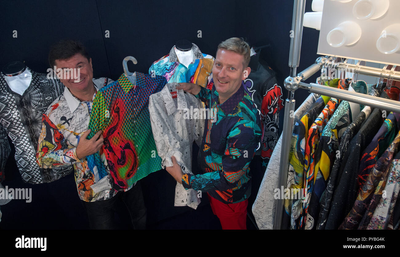 Leipzig, Germany. 26th Oct, 2018. 26 October 2018, Germany, Leipzig: Michael Kahnt (L) and Rene Koenig from the fashion label 'Germens' from Chemnitz present extravagant shirts with artistic motifs at the 'Designers' Open'. With 228 labels and players from more than eight countries, the fair starts on Friday (26.10.2018) and invites you to discover unusual designs and works until Sunday. Credit: Hendrik Schmidt/dpa-Zentralbild/dpa/Alamy Live News Stock Photo