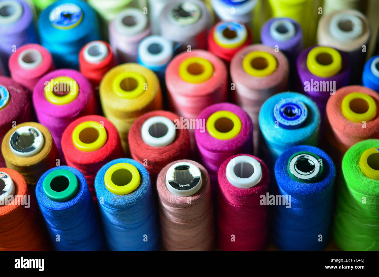 Sewing threads as a multicolored background closeup Stock Photo - Alamy