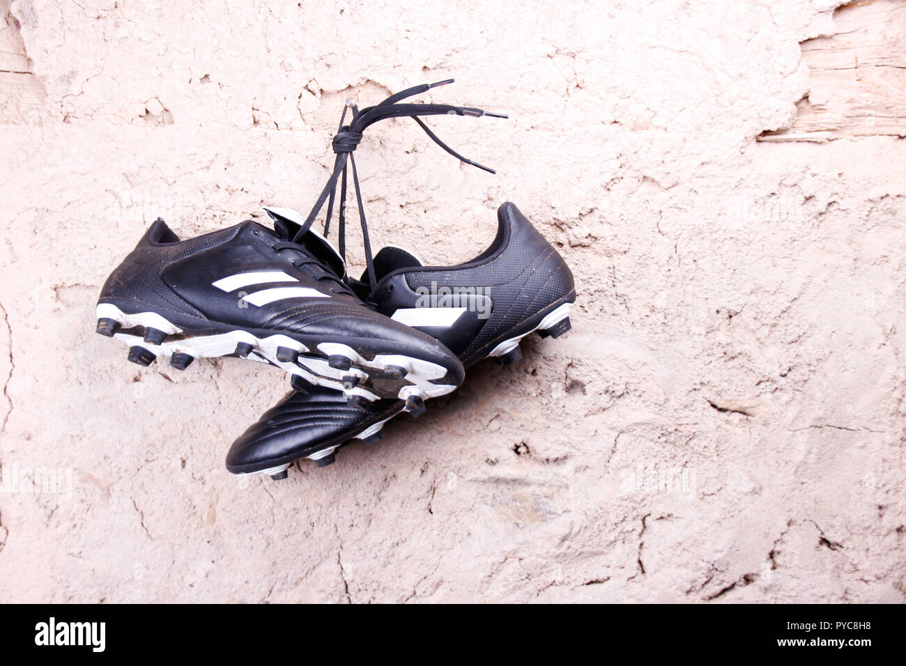 football boots hanging on the wall Stock Photo - Alamy