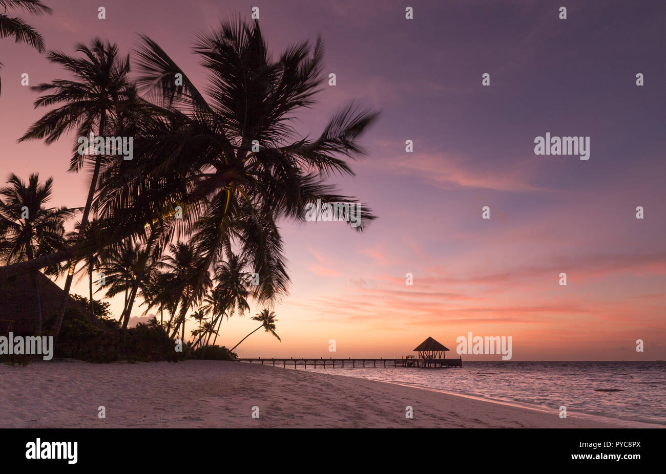 Sunset on the beach Atoll island Maldives. Stock Photo