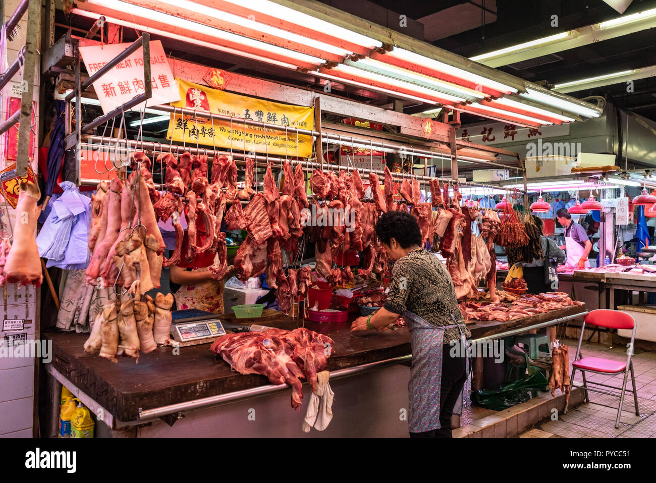 Meat stall and butcher at Shek Wu Hui Market, wet market interior, in Hong Kong, China SAR Stock Photo