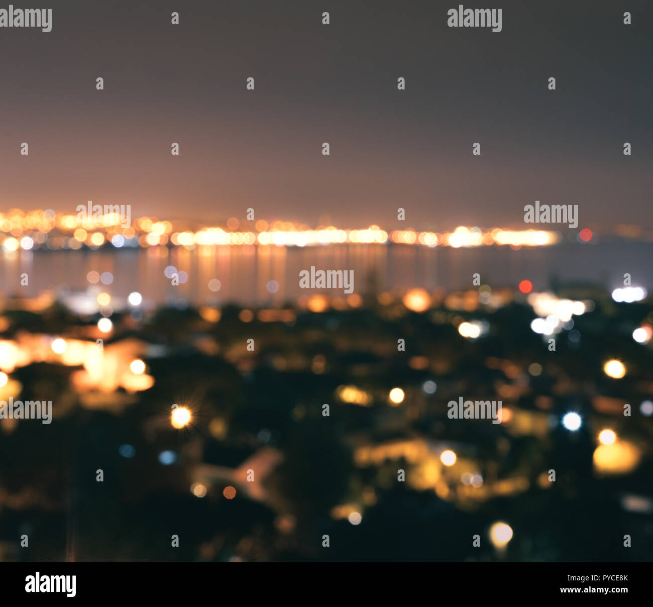 Purposely blurred bokeh lights at night with waterscape. Stock Photo