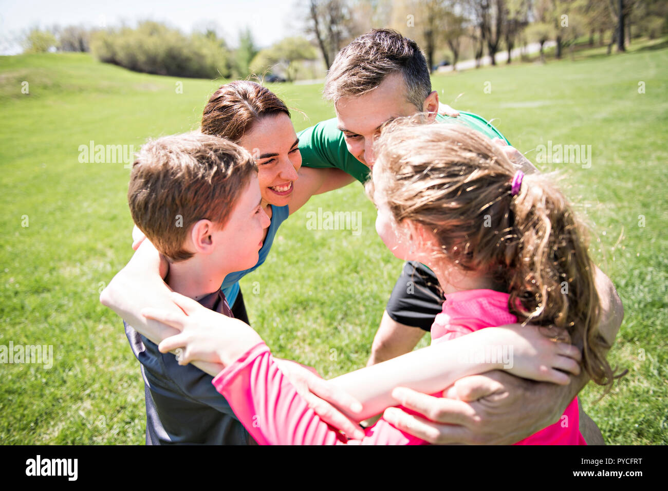 Parents with children sport running together outside Stock Photo - Alamy