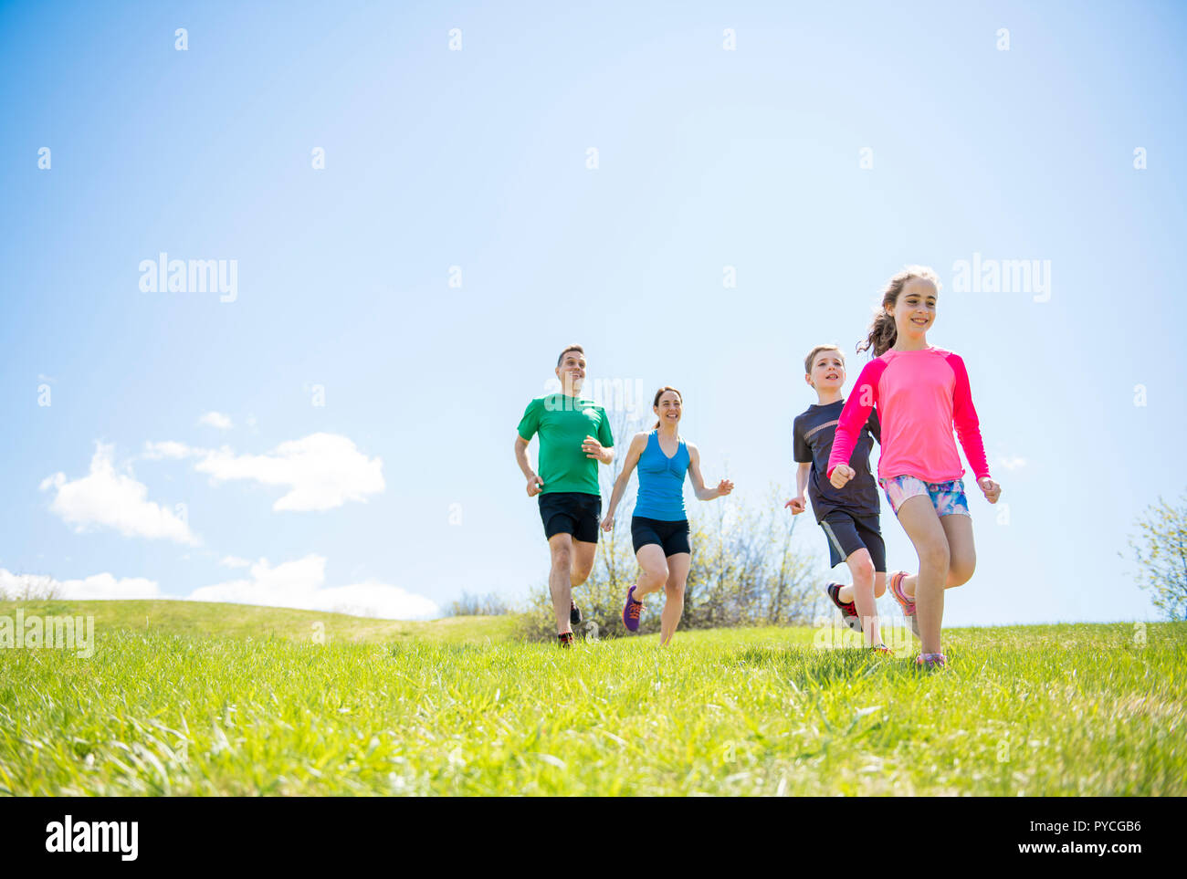 Parents with children sport running together outside Stock Photo