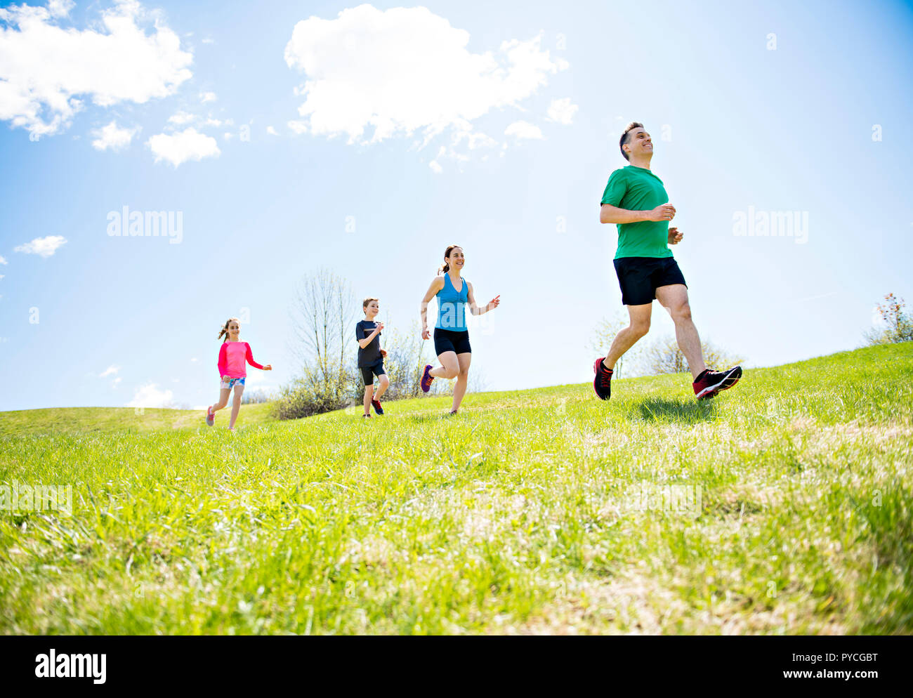 Parents with children sport running together outside Stock Photo