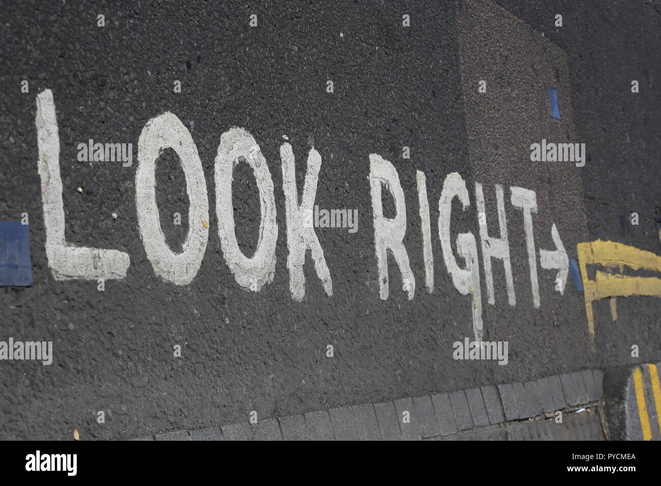 Look Right Road Sign, top view. White paint on the Crossroads in the streets of London reminding you to look right. Helpful  road sign to adjust to th Stock Photo
