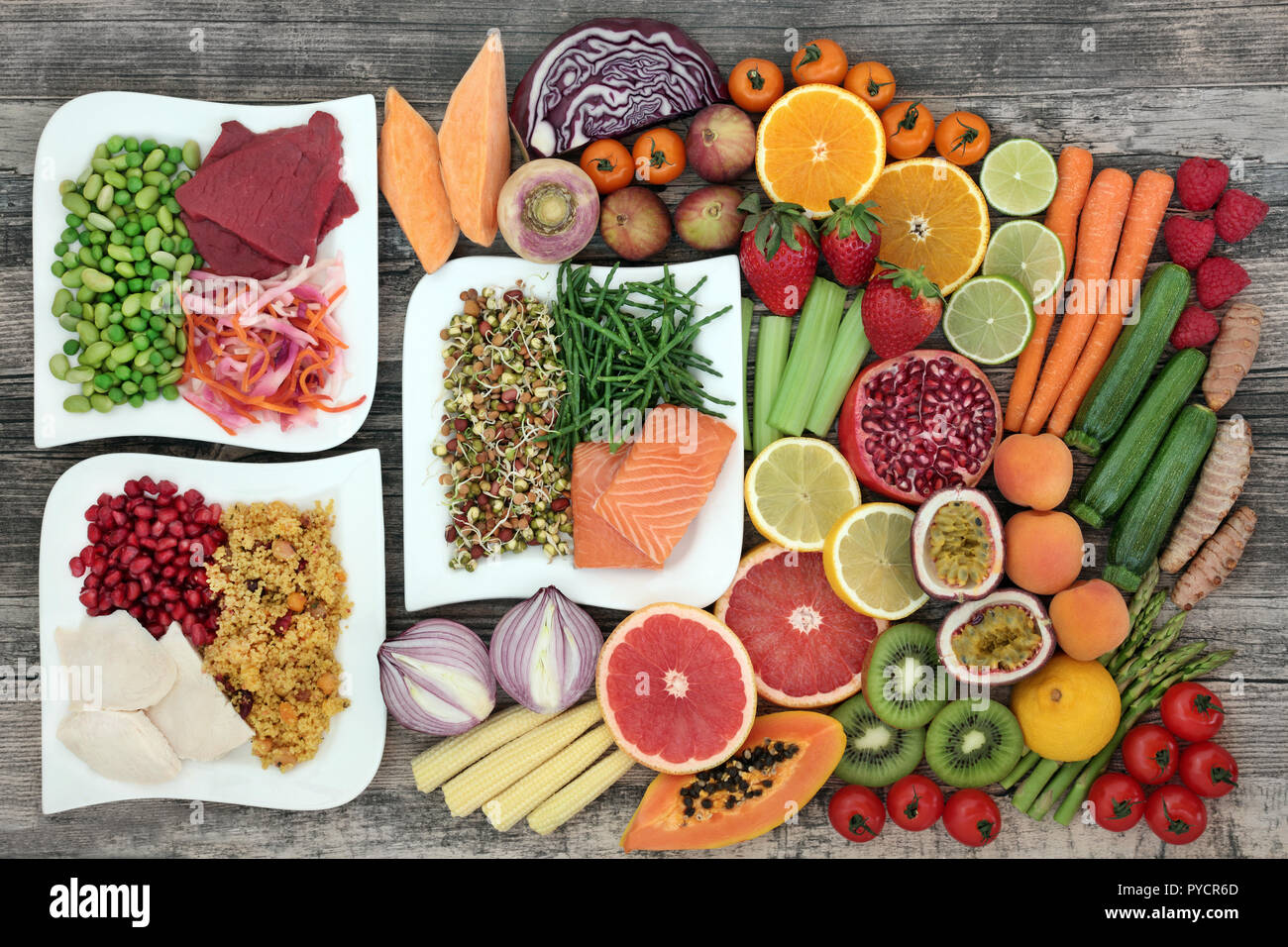 Diet health food concept with a large variety of vegetables, fruit, meat, fish, grain salad and spice with foods high in protein & antioxidants, Stock Photo