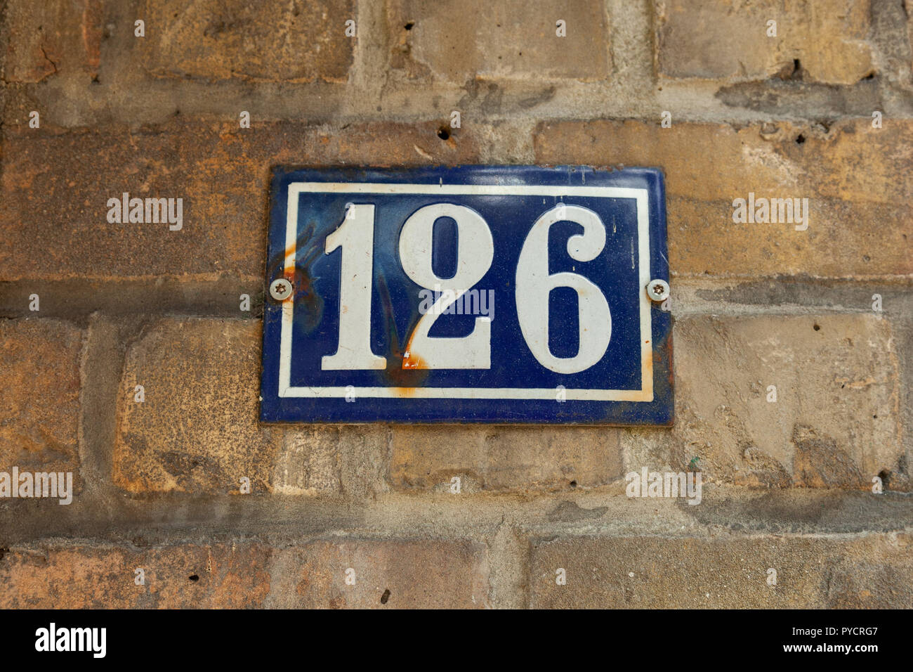 House number one hundred twenty-six 126 on enamel plaque in black and white from Belgium Stock Photo