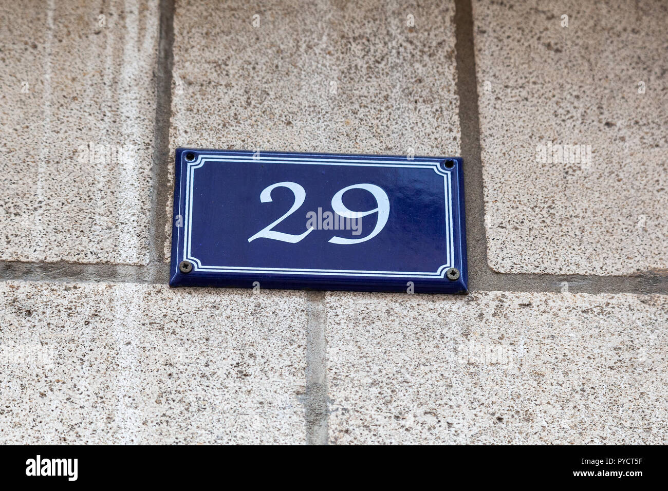House number twenty-nine 29 on enamel plaque in blue and white from Sweden or Paris, France Stock Photo