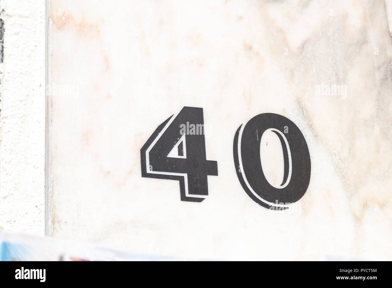 House number forty 40 painted blackin 3D on white render in modert font from Sweden Stock Photo