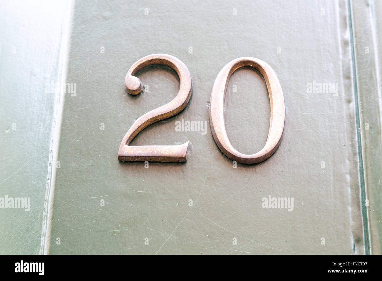 House number twenty 20 in cut out metal - brass, in designer font from Sweden Stock Photo