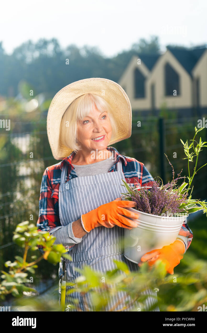Smiling pretty old woman spending a day outside Stock Photo