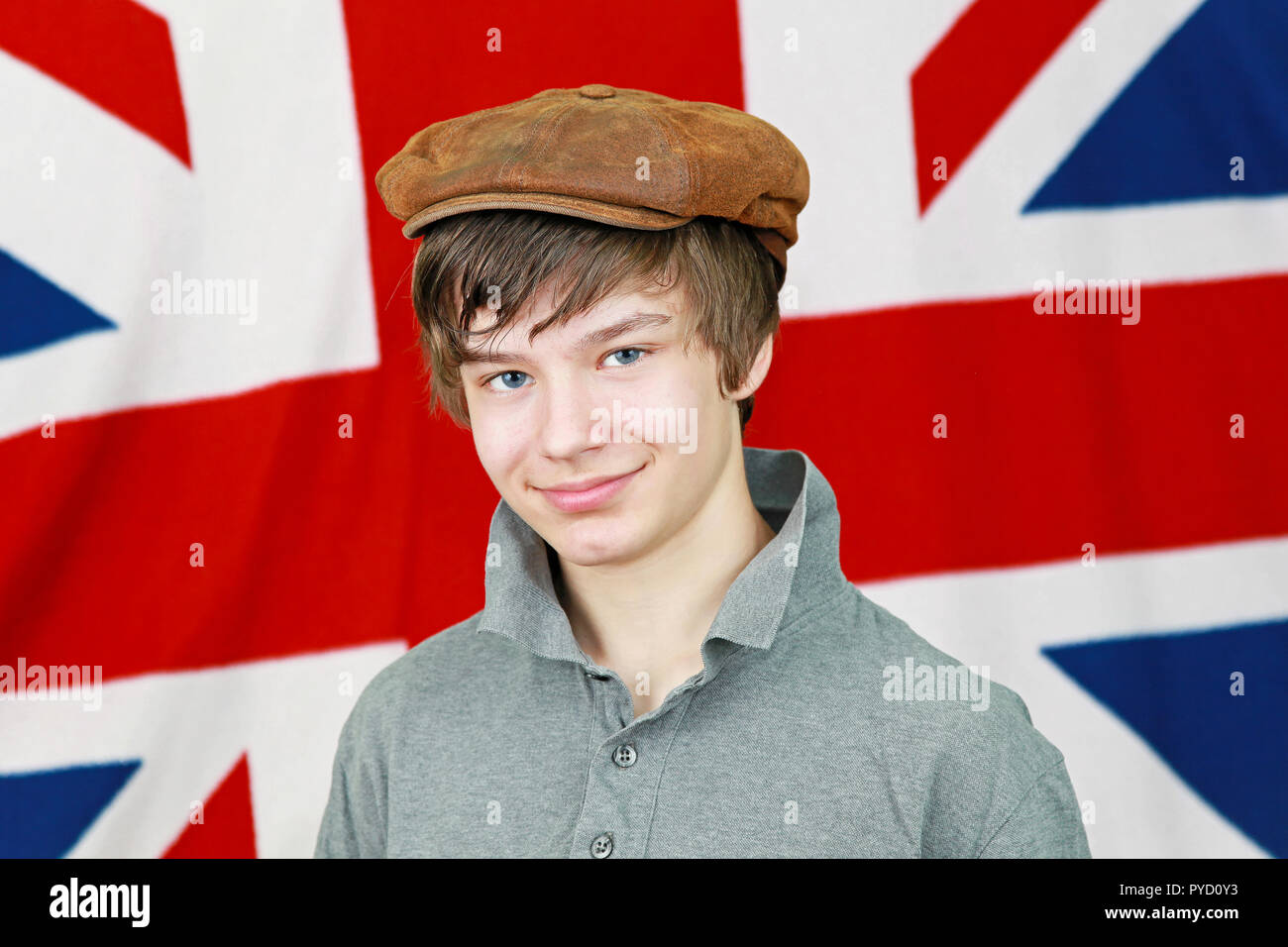 Young British boy with hat in front of Union Jack national flag Stock Photo