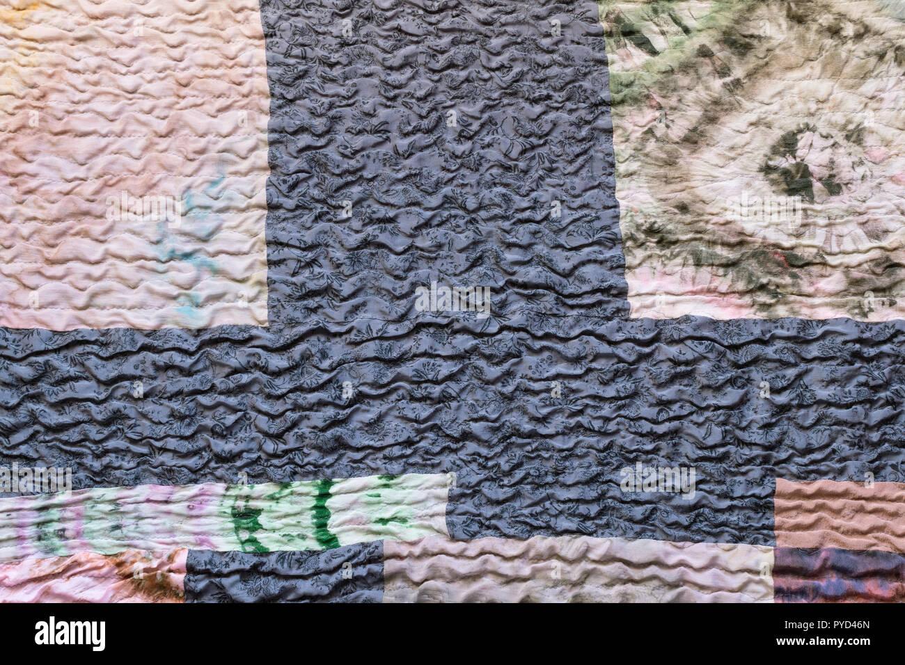 textile background from silk stitched scarf - various textured sewn pieces of patchwork cloth Stock Photo