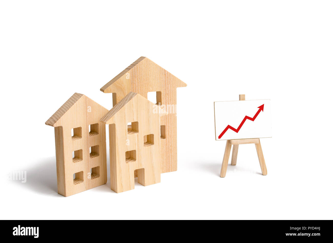 Wooden houses stand with red arrow up. Growing demand for housing and real estate. The growth of the city and its population. Investments. concept of  Stock Photo