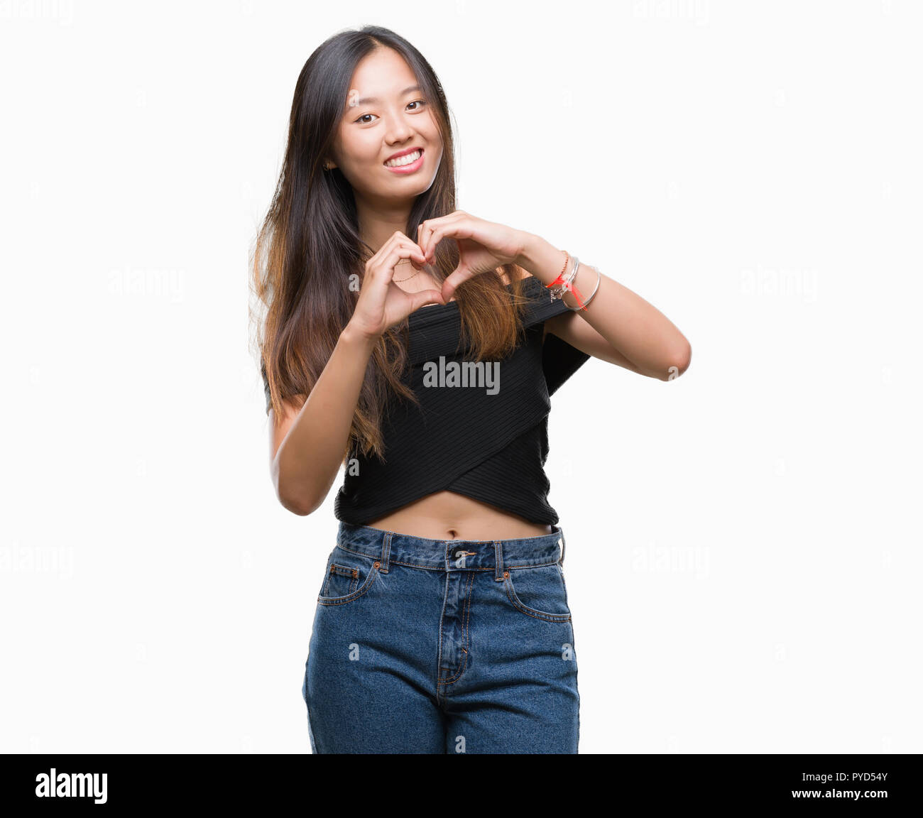 Young asian woman over isolated background smiling in love showing ...
