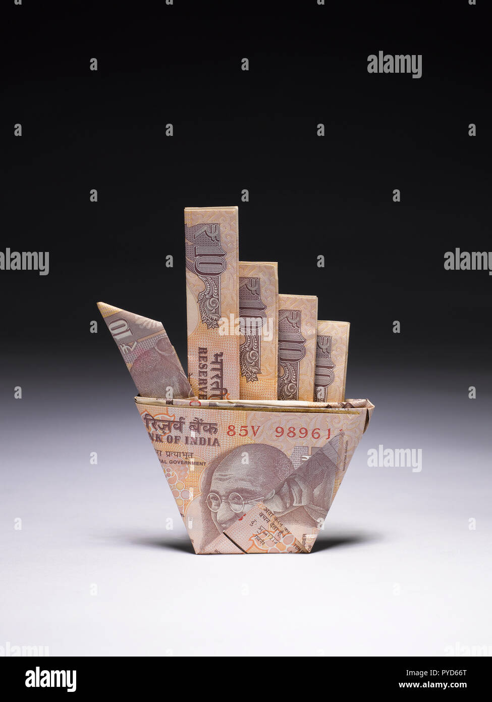 A Still Life Of A Hand Made With Currency Notes Using The Art Of - a still life of a hand made with currency notes using the art of origami