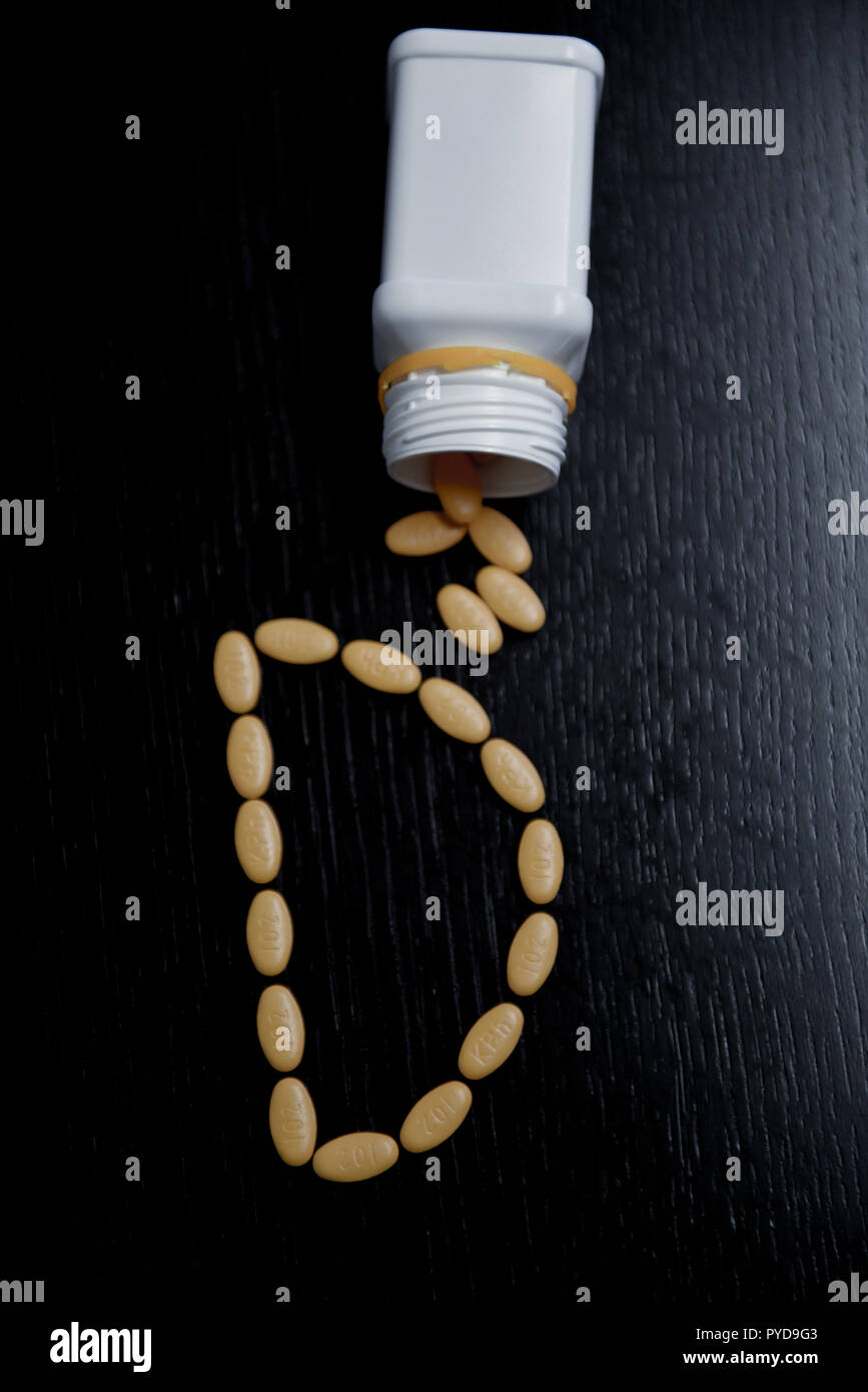 Top view of letter D made with yellow pharmaceutical pills Stock Photo