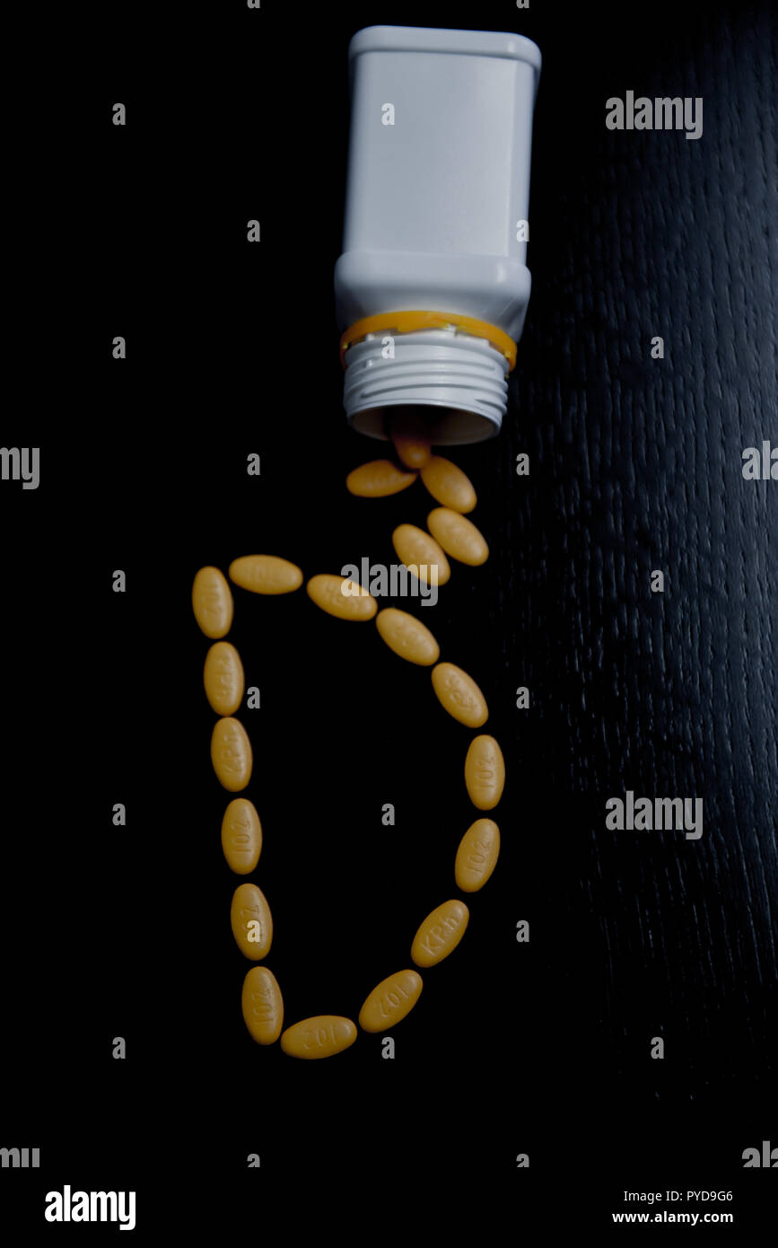 Top view of letter D made with yellow pharmaceutical pills Stock Photo