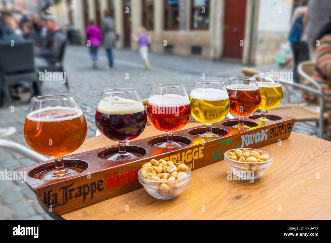 Various types of beer on wooden plate in the bar, Bruxelles Stock Photo